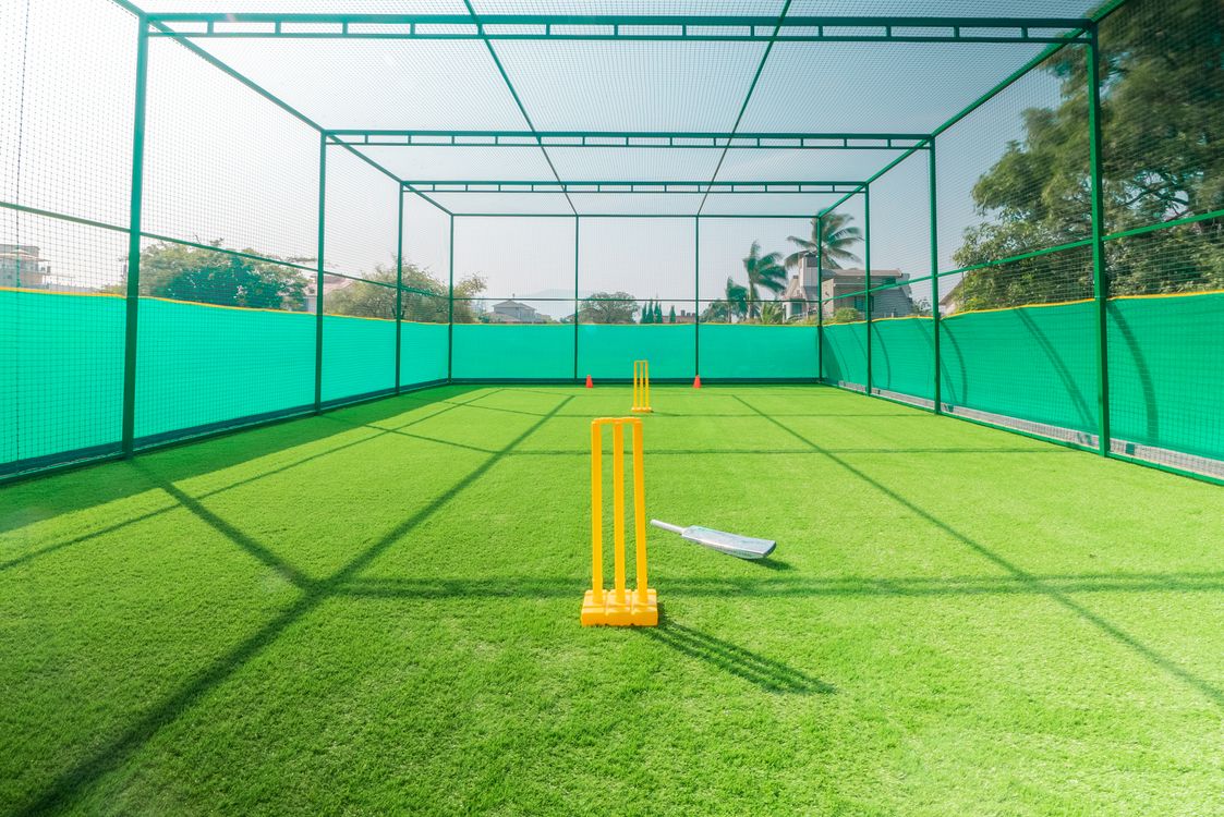 Box cricket practice nets and artificial turf pitch